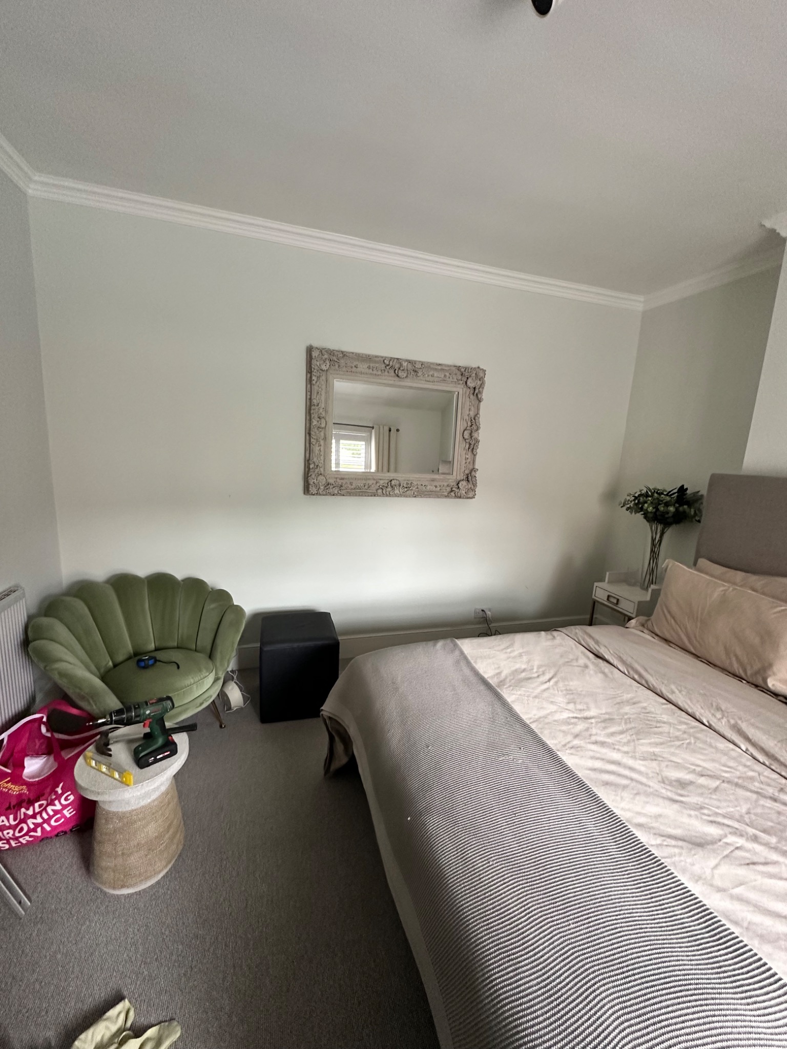 Large ornate mirror securely fitted to bedroom wall