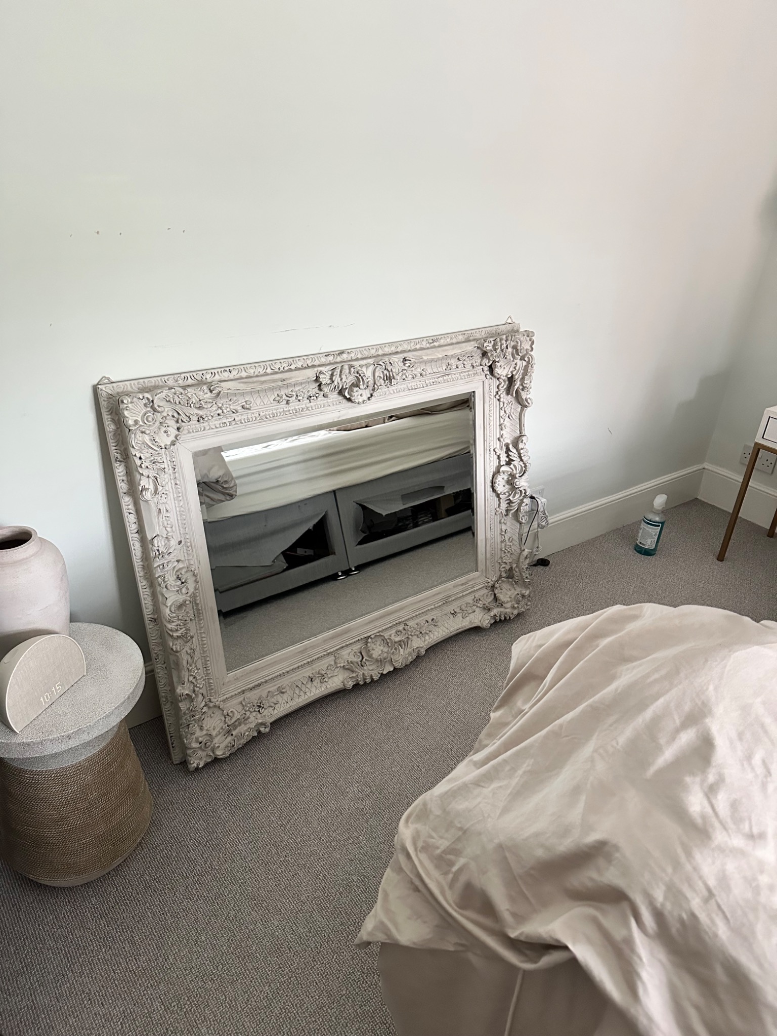 Large ornate mirror before wall fitting